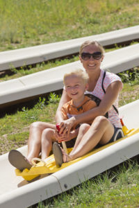 Mother and son on Alpine slide ride